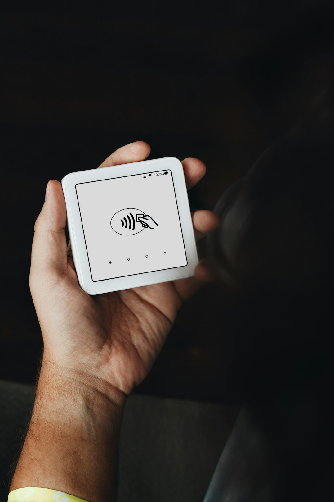 Hand holding a tablet showing a digital form interface