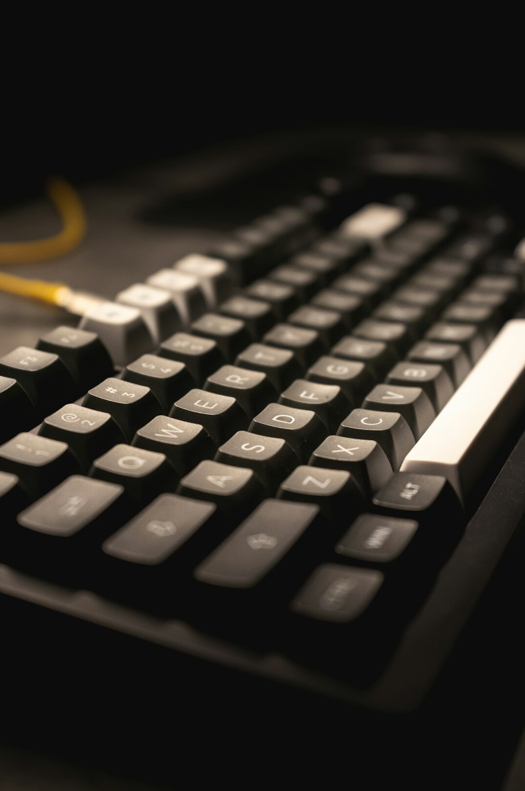 Hands typing on a keyboard with code on screen